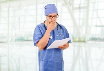 male doctor thinking with his notes, at the hospital