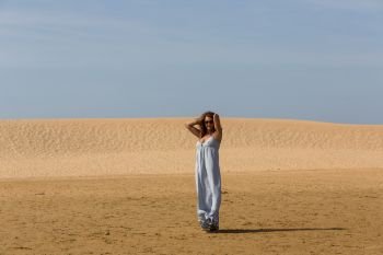 woman at the sand dunes of Praia da Bordeira, Algarve, the south of Portugal