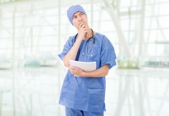 doctor thinking with his notes at the hospital