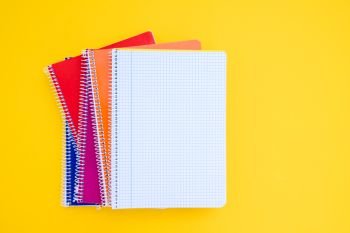 back to school concept minimalistic and creative scene with copy space on empty sheet on yellow. back to school