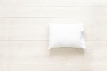 pillow in white linen on the wooden floor background. white pillow on the floor