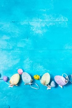 Easter eggs row on blue background with copy space. Easter eggs on bright blue background