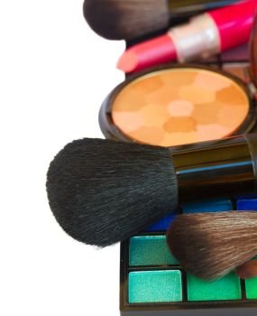 Decorative   make up cosmetics  -   brushes  and powder on eye shadowa palette  isolated on white background. Decorative cosmetics border