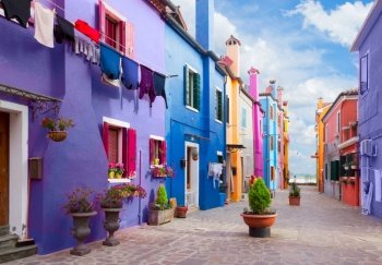 multicolored houses of Burano island with color of the year blue very peri, Venice, Italy. Burano island, Venice, Italy