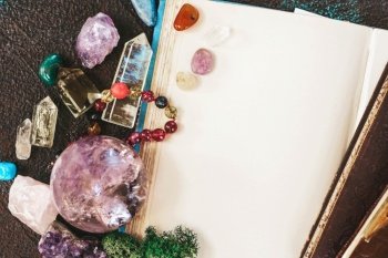 Empty book with copy space with gemstones set for relax and meditation. Magic ball and minerals for Reiki life balance, healing Crystal Ritual, Witchcraft, spiritual esoteric practice.. Healing crystals concept