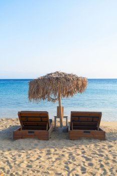 summer beach with sunbeds, Mykonos island, Greece. Mykonos island, Greece