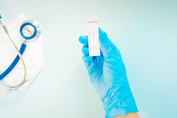 nasal antigen covid 19 test, nurse in blue gloves shows covid 19 test. nasal antigen covid 19 test