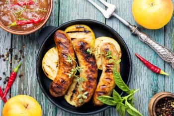 Delicious sausages grilled with spicy spices and apples.BBQ. Tasty grilled pork sausages