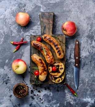 Tasty grilled sausages on wooden cutting board.Bavarian sausages.German food. Delicious grilled sausages