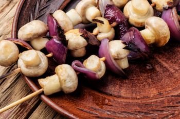 Grilled mushrooms on wooden skewers. Vegetable shish kebab. Vegetable kebab with mushrooms