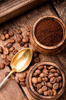 Roasted coffee beans and ground coffee.Coffee beans on wood background. Ground coffee and beans