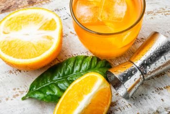 Fresh cocktail with orange and ice.Glass of orange drink. Orange drink with ice