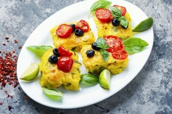Polenta with tomatoes and cheese.Italian cuisine.Pieces corn polenta. Polenta Italian cornmeal dish