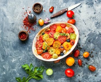 Baking tray with cherry tomatoes.Vegetarian meal.Vegetarian food,baked tomatoes. Oven baked tomatoes
