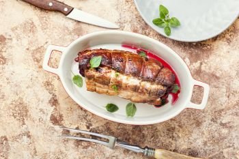 Roasted pork with cherry filling.Baked pork in a baking dish. Baked pork meat with cherry