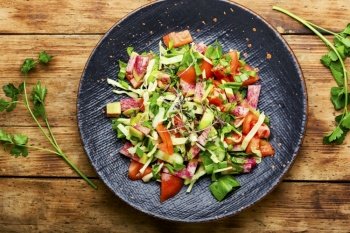 Vegetable salad with tomato,cucumber,radish and microgreens.Spring vitamin salad..Homemade food. Healthy vegetarian salad,spring food