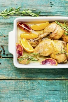 Delicious chicken baked with oranges and rosemary in a baking dish.Baked chicken drumstick. Tasty chicken drumstick baked with oranges