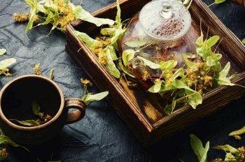 Healing linden tea in a glass teapot. Fragrant natural tea. Herbal medicine.. Fragrant linden tea