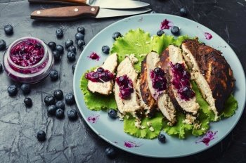 Grilled chicken breast with blueberry sauce. Sliced barbecued chicken breasts. Chicken breast with huckleberry sauce