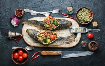 Seafood baked fish stuffed with broccoli,quinoa and tomato. Tasty baked whole fish