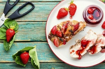 Sliced chicken breast with strawberry berry sauce on the plate.Grilled chicken breast. Chicken meat baked with strawberry