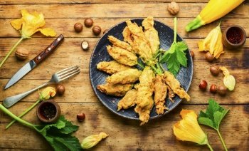 Fried zucchini flowers stuffed cottage cheese.Roasted courgette flowers.Healthy food,stuffed squash blossoms. Stuffed fried zucchini flowers,top view