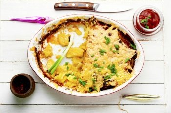 French meat is a dish made from layers of meat, potatoes and cheese. Meat and potato casserole. Baked meat with potatoes and cheese.