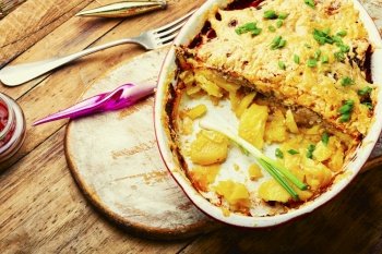 Veal, potato and cheese casserole. Meat gratin with potatoes and cheese. French meat, a popular dish for the festive table.