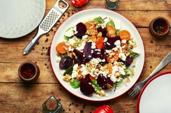 Salad of beets, carrots, nuts and cottage cheese. Autumn salad. Tasty salad with cottage cheese and vegetable