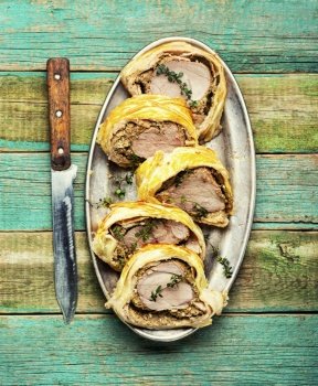 English dish of beef tenderloin in puff pastry stuffed with mushrooms. Wellington Meat. Wellington pork, pork tenderloin baked with mushrooms in puff pastry.