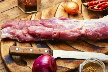 Tasty raw pork meat for cooking. Raw meat tenderloin and spices set. Uncooked pork meat, fresh meat