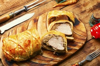 Juicy meat in a dough with spices, mushroom or vegetable pate. Wellington meat.. Wellington meat is a festive tenderloin dish.