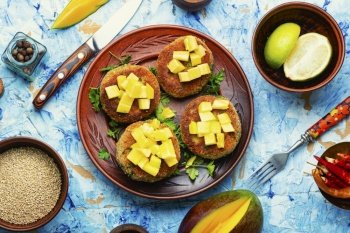 Dietary vegan quinoa cutlets with mango, vegetarian food. Vegan quinoa burgers