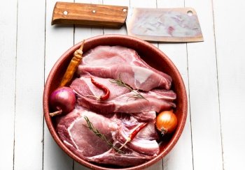 Fresh, raw pork meat on the bone. Raw chop on the bone. Flat lay. Raw and fresh pork.