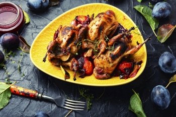 Roasted tasty quail in plum sauce. Meat with plum.. Quail baked fall plums.