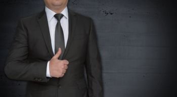 Businessman with thumbs up and copyspace.. Businessman with thumbs up and copyspace