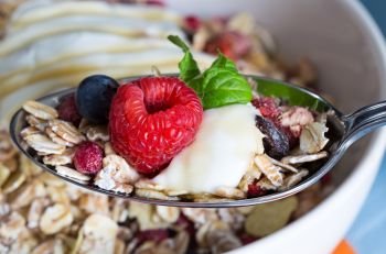 Cereal with yogurt and fruits on wood.. Cereal with yogurt and fruits on wood