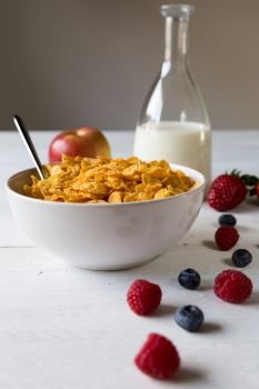 Cornflakes in a bowl with milk and fruits.. Cornflakes in a bowl with milk and fruits