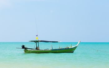 White sand beach and boat in blue sky.. White sand beach and boat in blue sky