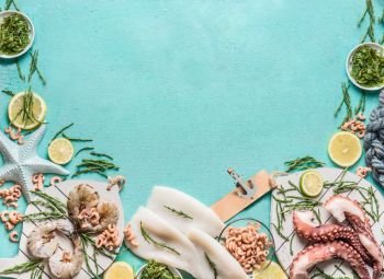 Seafood background with squid, prawn or tiger shrimp, octopus, North Sea crabs and seaweed on light blue, top view, border. Place for your design, text, recipes or products