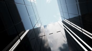 Low angle view of generic modern office skyscrapers ,high rise buildings with abstract geometry glass facades . Concepts of finances and economics background. 3d rendering .