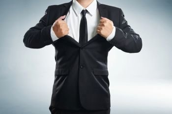 young businessman in superhero action with black suit