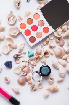 fashion summer coral eye palettes with  natural shells and gemstones around background. close up