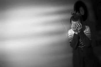 crying woman covering her face. Black and white photography