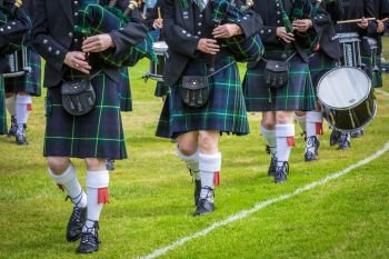 Pipers in kilts walking
