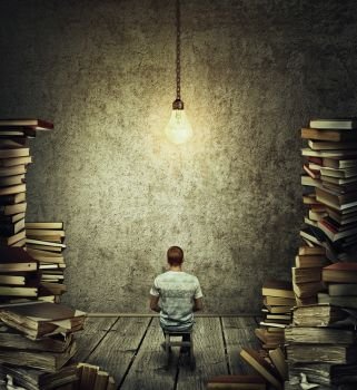 Creative idea concept as a person, scribe sitting in a dark room surrounded by tall piles of books and a suspended glowing lightbulb above his head. Wise librarian or writer get inspiration. 