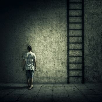Abstract idea with a person standing in a dark room, in front of a concrete wall, figuring a ladder to escape. Surrounded by limitations, daily routine.