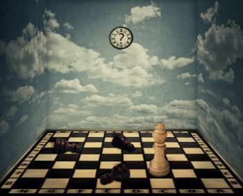 Business idea as a magical room with a chess board floor surrounded by the walls with clouds texture as limitations and the king piece winning in front of beaten pawns laying down. Victory concept.