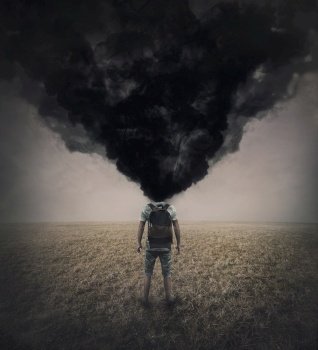 Surreal scene of a lone man in the field with dense black smoke instead his head. Fatigue and annoyed person suffering emotional crisis. Mental burnout and explosion. Depression and despair concept