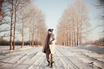 fashionable man in a coat / winter style, walk against the backdrop of the winter landscape, snowy weather, warm clothes